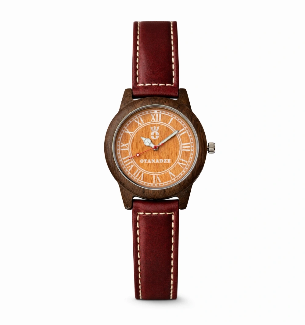 OTANADZE Eclipse Sunset Edition watch with a vibrant orange wood dial, Roman numerals, and a dark walnut wood case. The watch features a deep cherry red leather strap with white contrast stitching, shot against a clean white background.