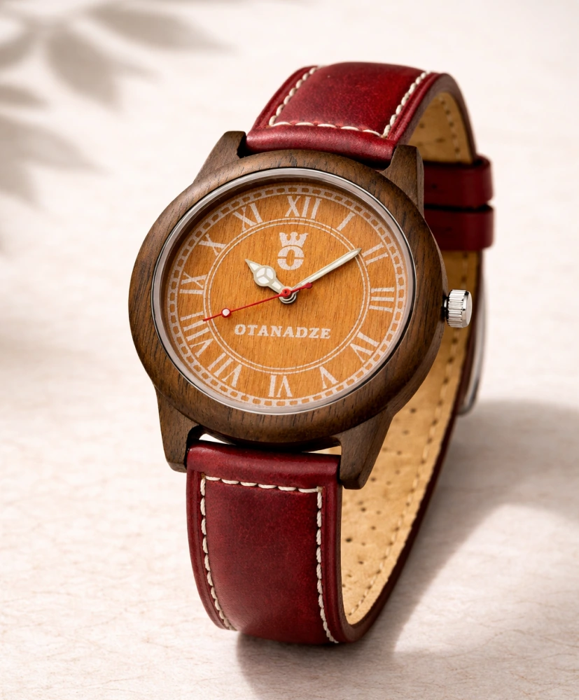 OTANADZE Eclipse Sunset Edition watch with a vibrant orange wood dial, Roman numerals, and a dark walnut wood case. The watch features a deep cherry red leather strap with white contrast stitching, shot against a clean white background.