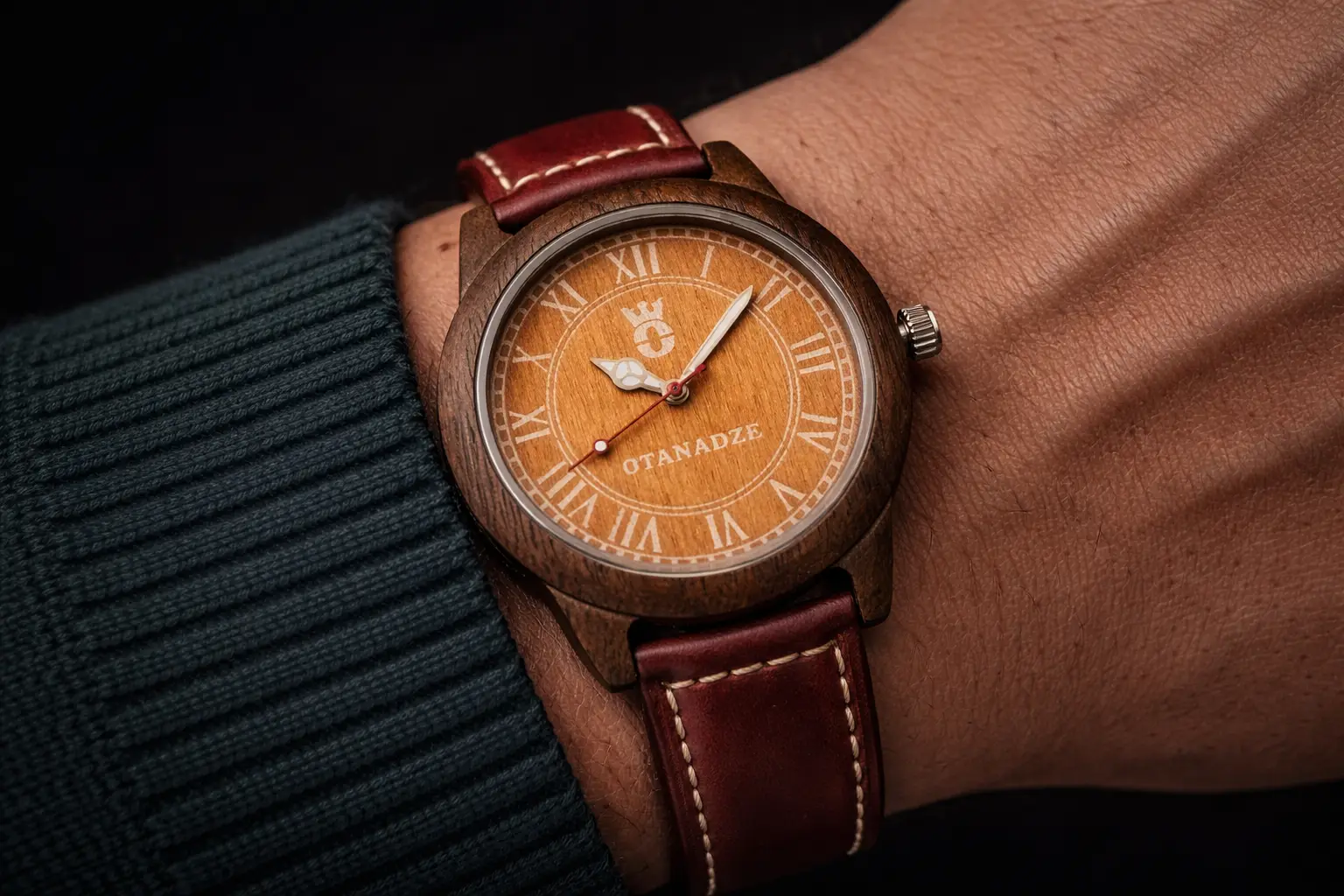 OTANADZE Eclipse Sunset Edition watch with a vibrant orange wood dial, Roman numerals, and a dark walnut wood case. The watch features a deep cherry red leather strap with white contrast stitching, shot against a clean white background.